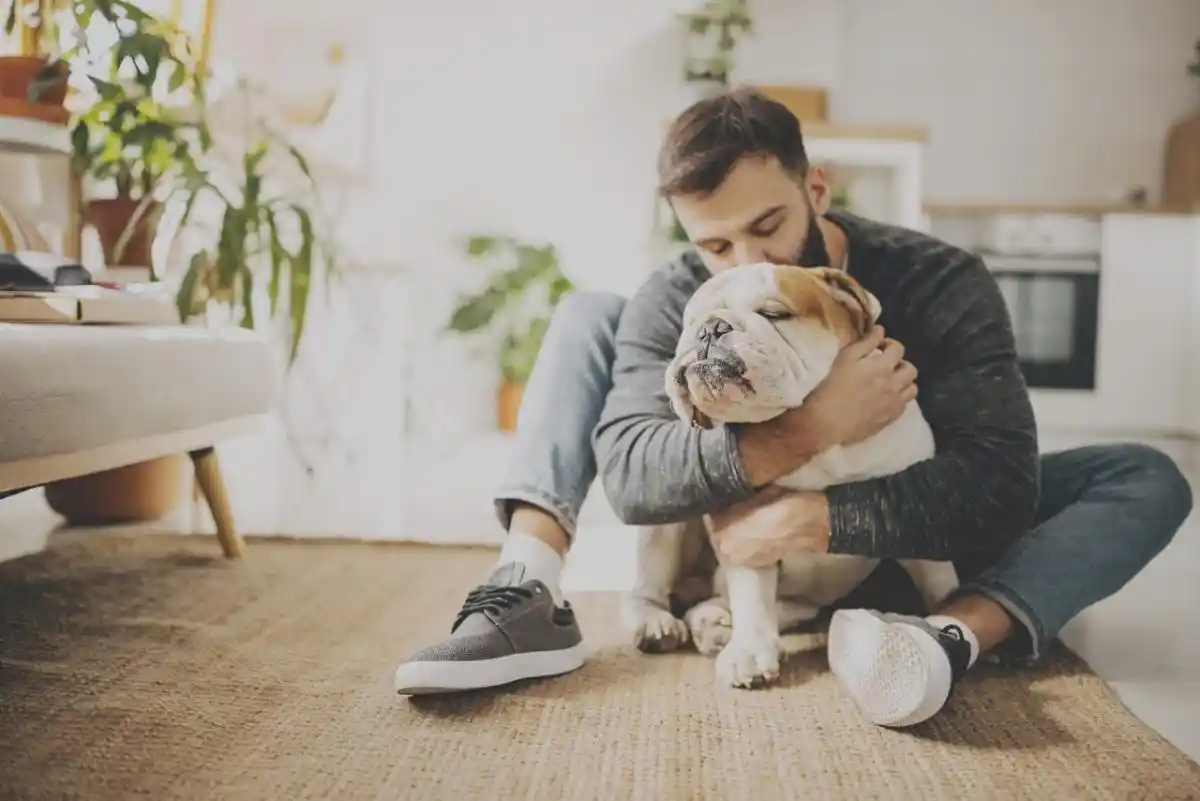 man hugging dog